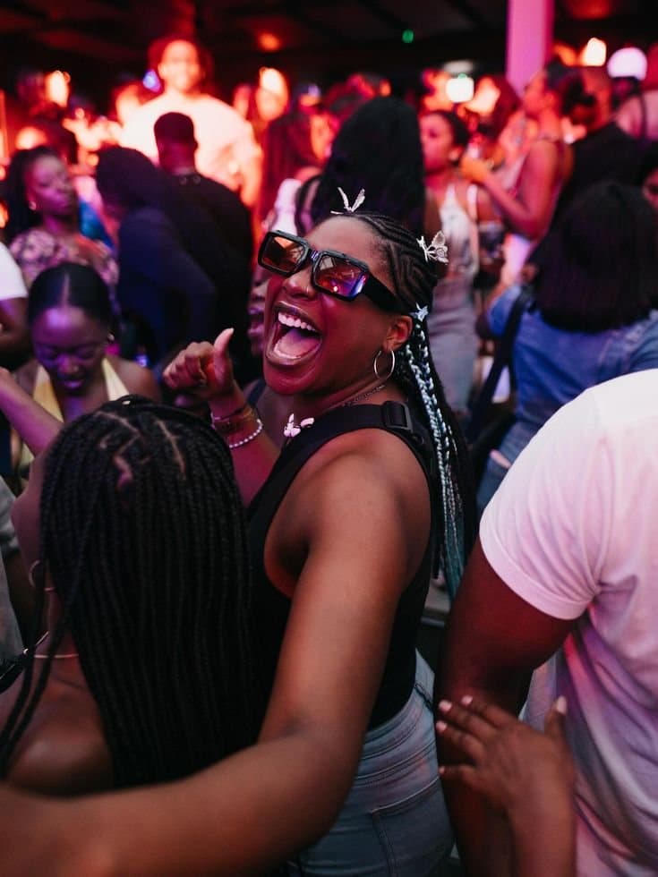 Woman in sunglasses dancing in a crowd