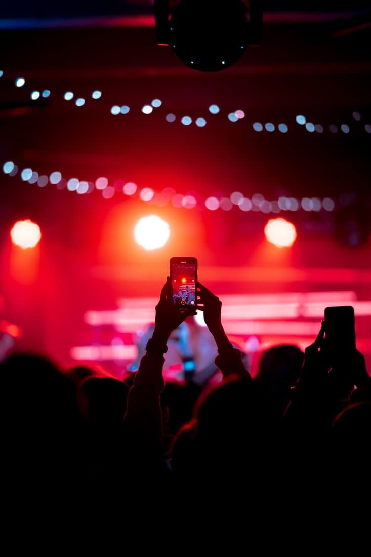 Crowd filming a concert stage